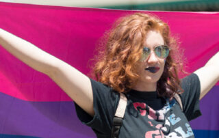 woman with flag for bisexual awareness