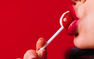 woman sucking a lollypop