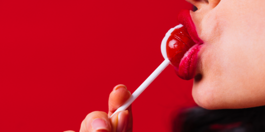 woman sucking a lollypop