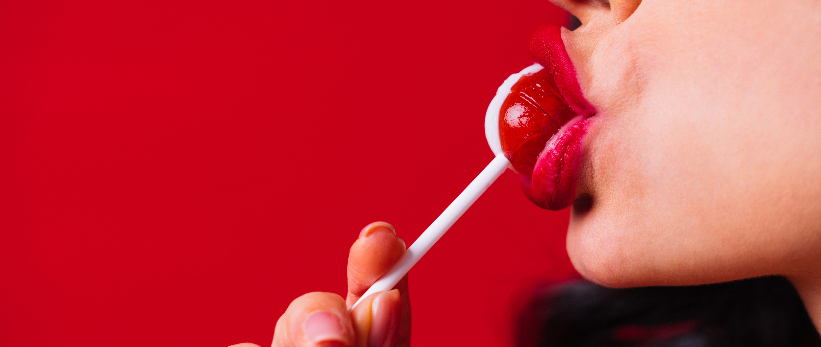 woman sucking a lollypop