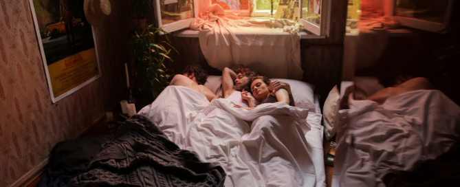 A non-monogamous trio in bed together showing that relationship jealousy is something that everyone can manage