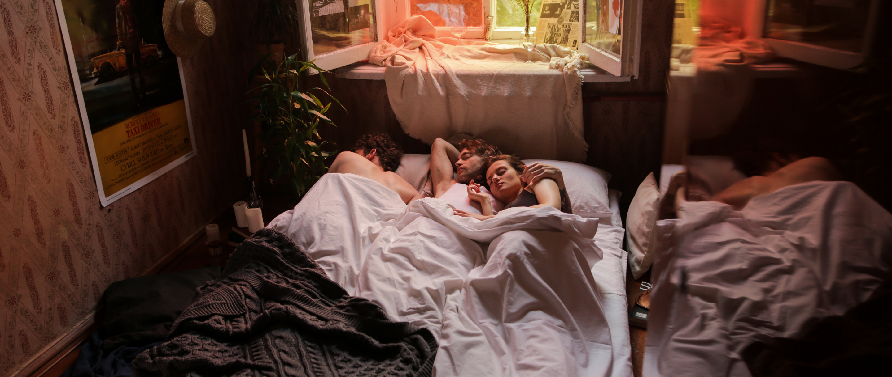 A non-monogamous trio in bed together showing that relationship jealousy is something that everyone can manage