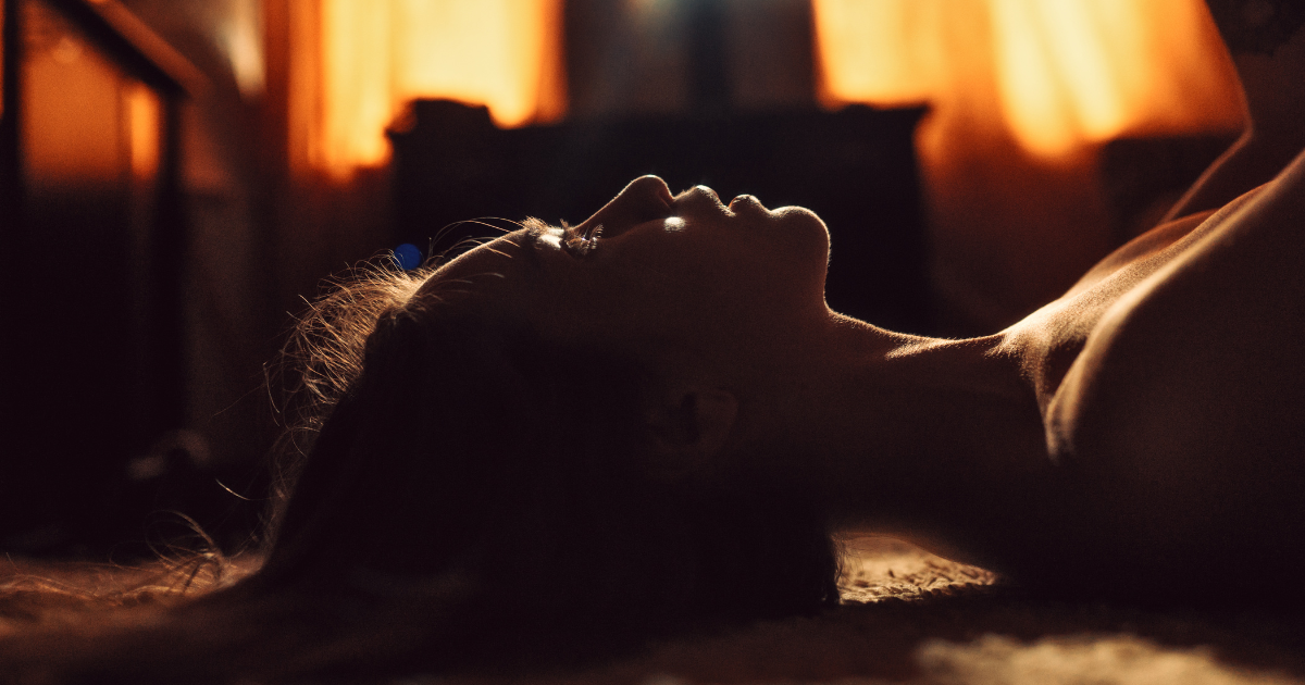 woman lying in a dark room with porn guilt